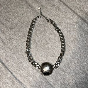 Woman’s silver colored necklace